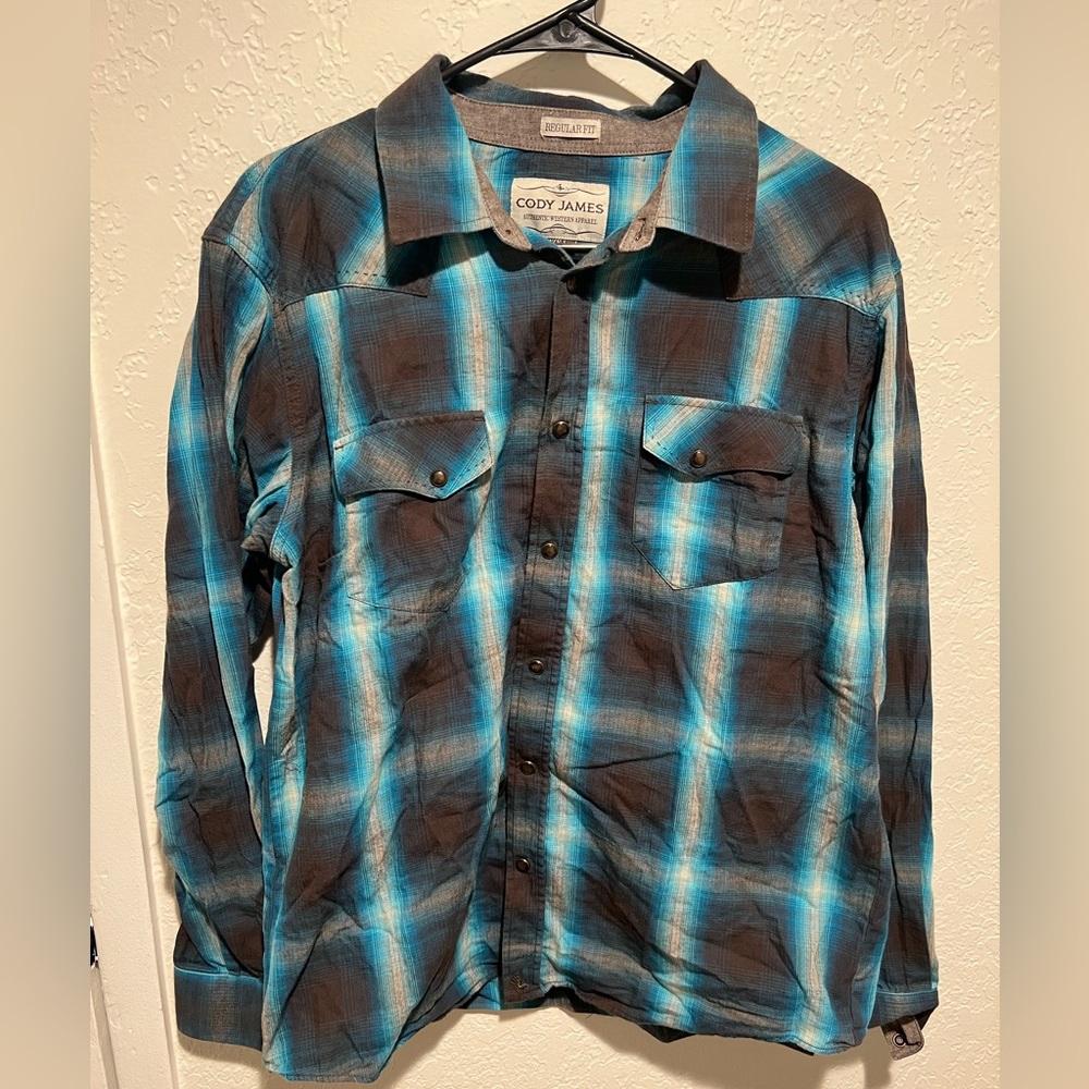 This is a Cody James dress shirt size large and it is blue and a blueish grey